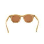 Beige sunglasses with brown lenses on a white background