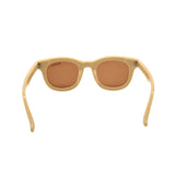 Beige sunglasses with brown lenses on a white background