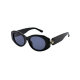 Black sunglasses with a gold accent on a white background