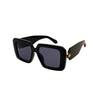Black sunglasses with a gold accent on a white background