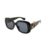 Black sunglasses with gold accents on a white background