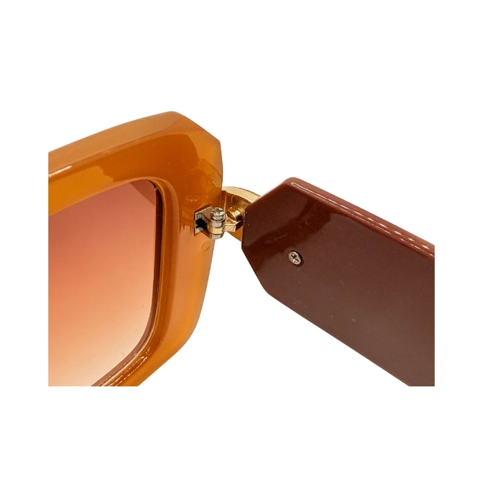 Close-up of a pair of sunglasses with brown gradient lenses on a white background