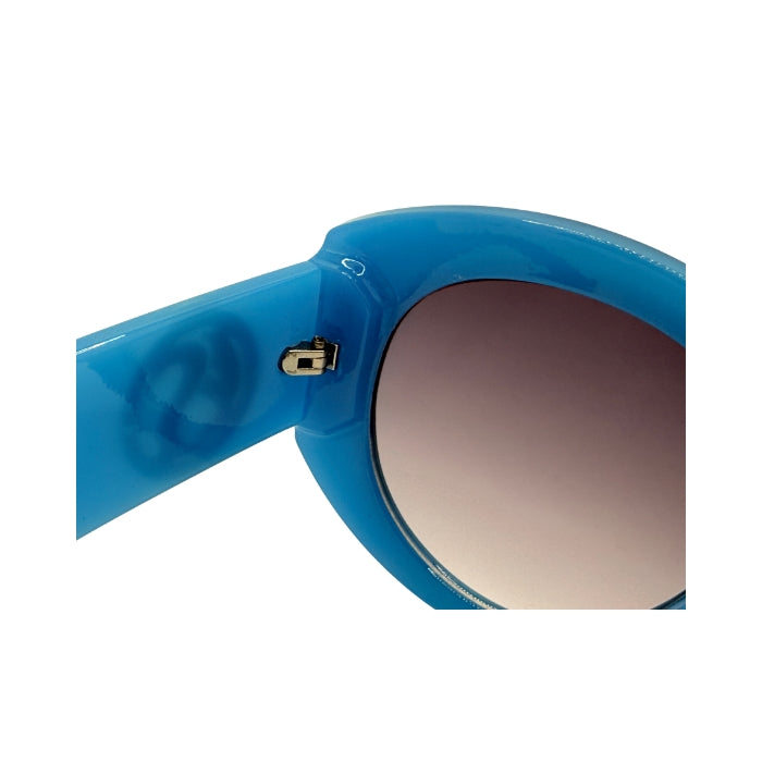 Close-up of blue sunglasses with a gradient lens on a white background