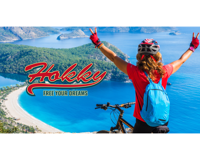 A person on a bicycle overlooking a scenic coastal view, promoting a gift card for sunglasses.
