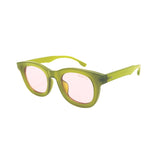 Green eyeglasses with pink lenses on a white background