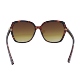 Sunglasses with tortoiseshell frame and brown gradient lenses on a white background