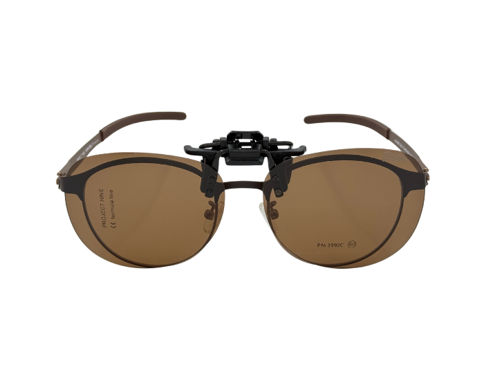 A pair of clip-on sunglasses with a brown frame and lenses.