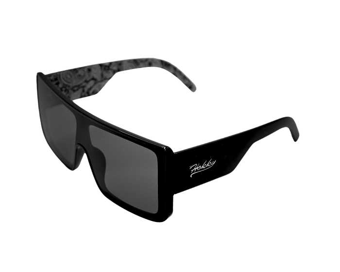 A pair of 'El Jefe' sunglasses with a bold rectangular frame and black mirrored lenses, featuring a patterned interior on the temples.