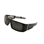 Black sunglasses with skull designs on the arms against a white background