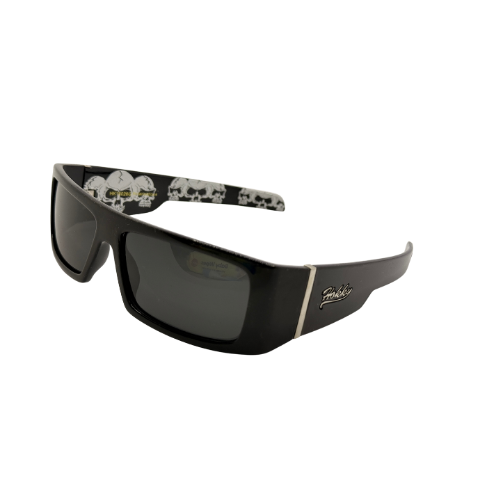 Black sunglasses with skull designs on the arms against a white background