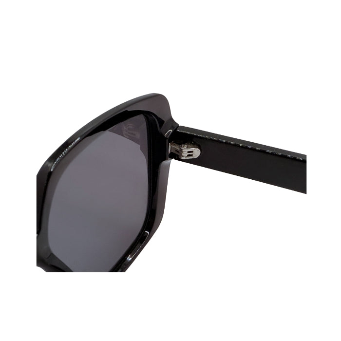 Close-up of black sunglasses showing the frame and hinge detail