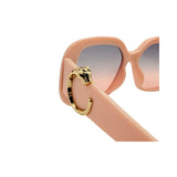 Pink sunglasses with gold accents on a white background