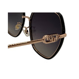 Sunglasses with gold frame and black lenses on a white background