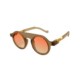 Sunglasses with gold frame and orange gradient lenses on a white background