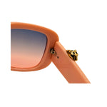 Sunglasses with peach frame and gradient lenses on a white background