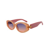 Sunglasses with pink frame and gradient lenses on a white background