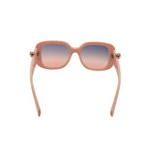 Sunglasses with pink gradient lenses and gold accents on a white background