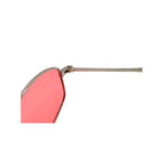 Sunglasses with pink lenses and gold frame on a white background