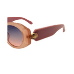 Sunglasses with rose gold frame and pink arms on a white background