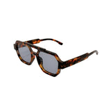 Sunglasses with tortoiseshell frame and dark lenses on a white background