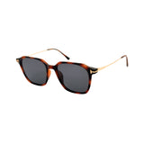 Sunglasses with tortoiseshell frame and dark lenses on a white background