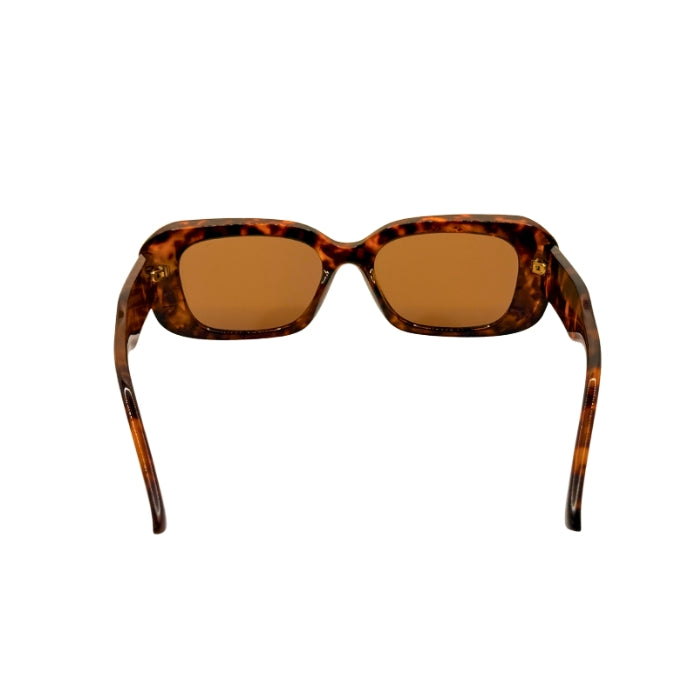 Sunglasses with tortoiseshell frame and brown lenses on a white background