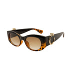 Sunglasses with tortoiseshell frame and brown lenses on a white background