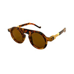 Sunglasses with tortoiseshell frame and brown lenses on a white background